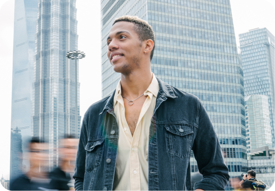 Male student in the city. Motion blur background.
